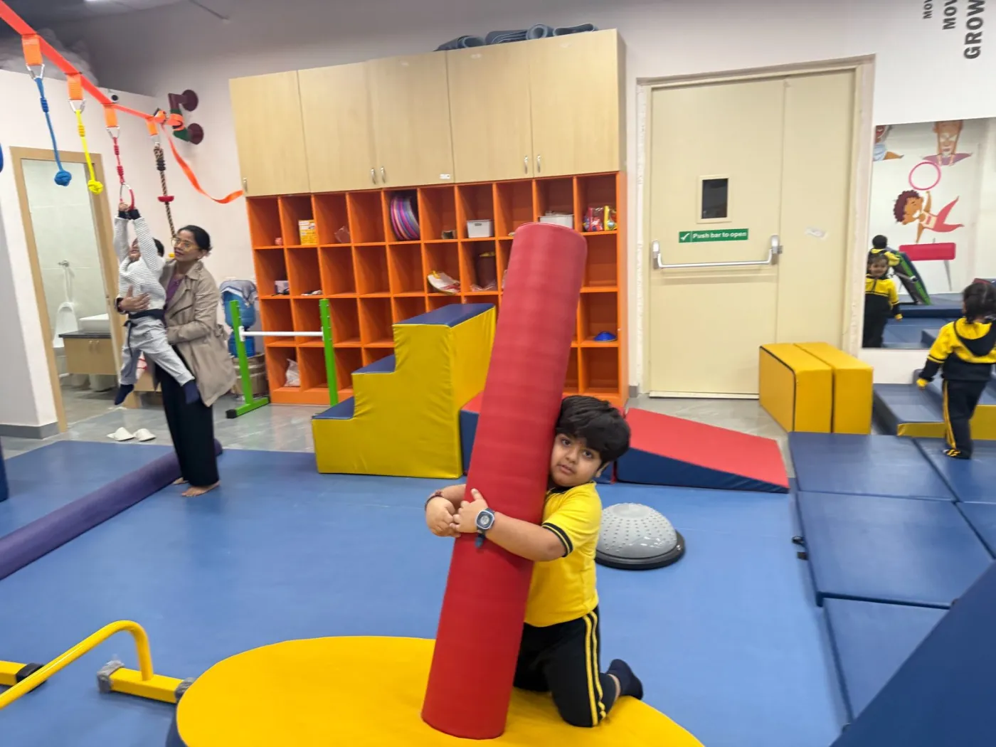 A child working with equipment during a strength and coordination drill