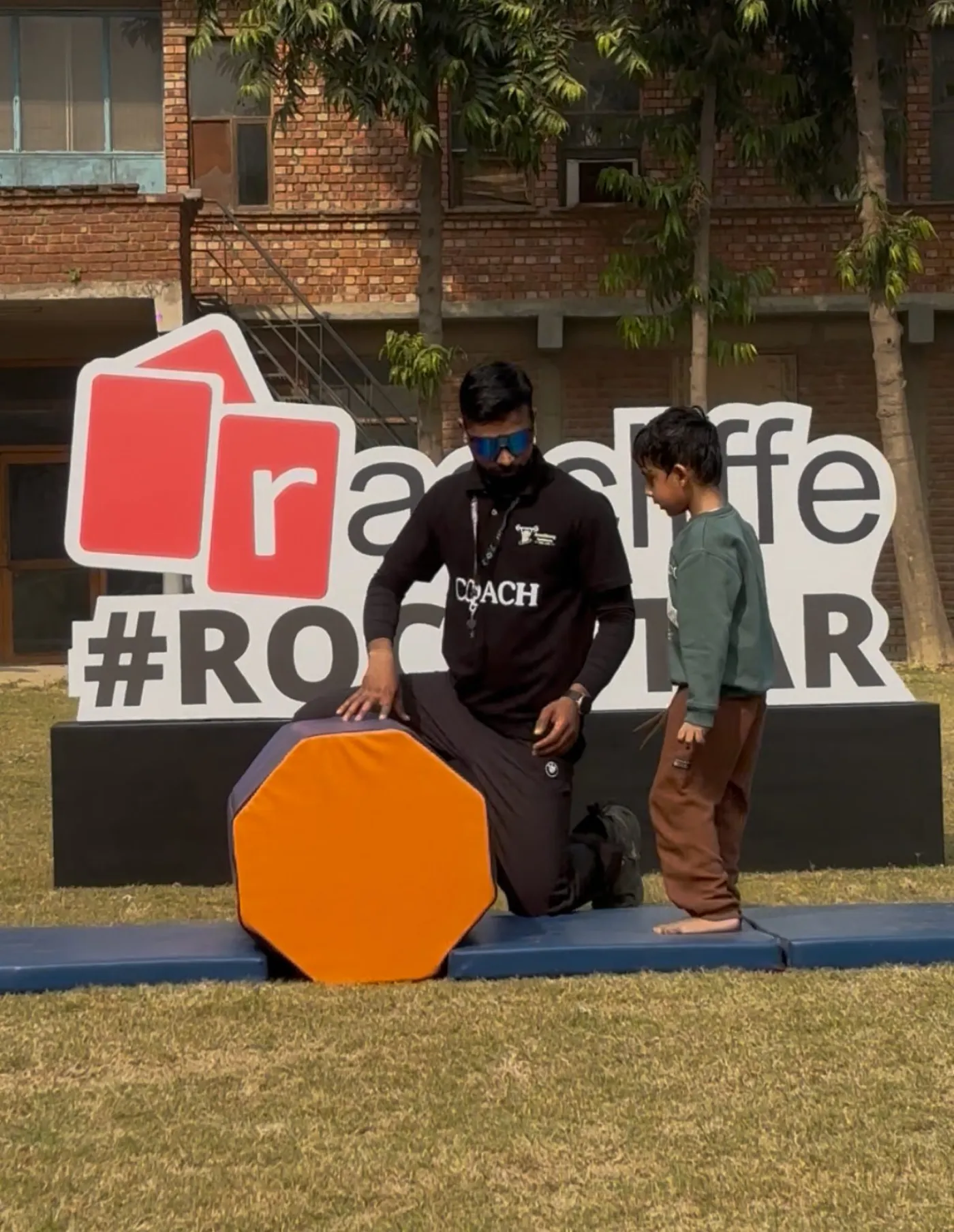 A GrowStrong coach running an outdoor adventure activity on a school ground